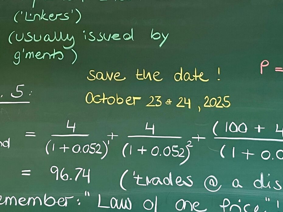 Chalkboard with financial formulas and a 'Save the Date' note for October 23 & 24, 2025, written in yellow chalk.