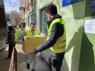 Helfer tragen die Spenden aus Lübeck in ein Lager in der Ukraine. Foto: Gedankendach e.V. 